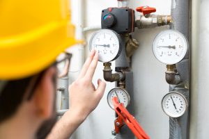technician checking pressure meters
